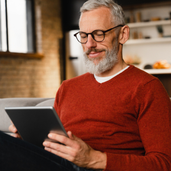 Person with glasses looking at tablet